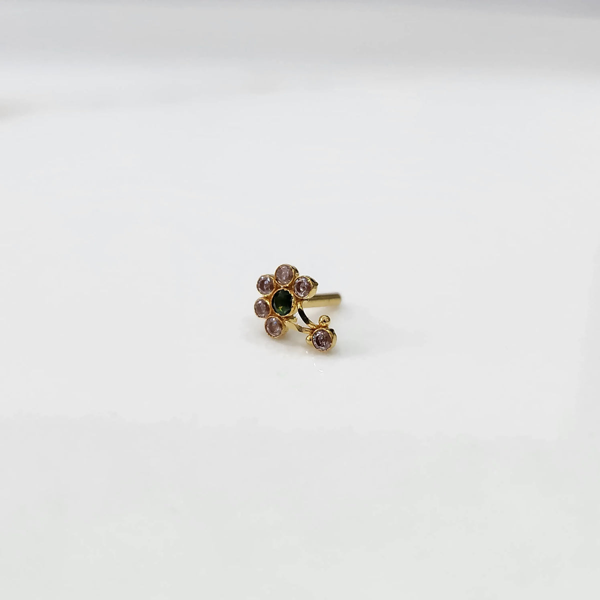 Gold ring with clear and green flower cluster and dangling drop stone