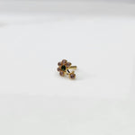 Gold ring with clear and green flower cluster and dangling drop stone