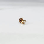 Gold ring with clear and red flower cluster and dangling drop stone
