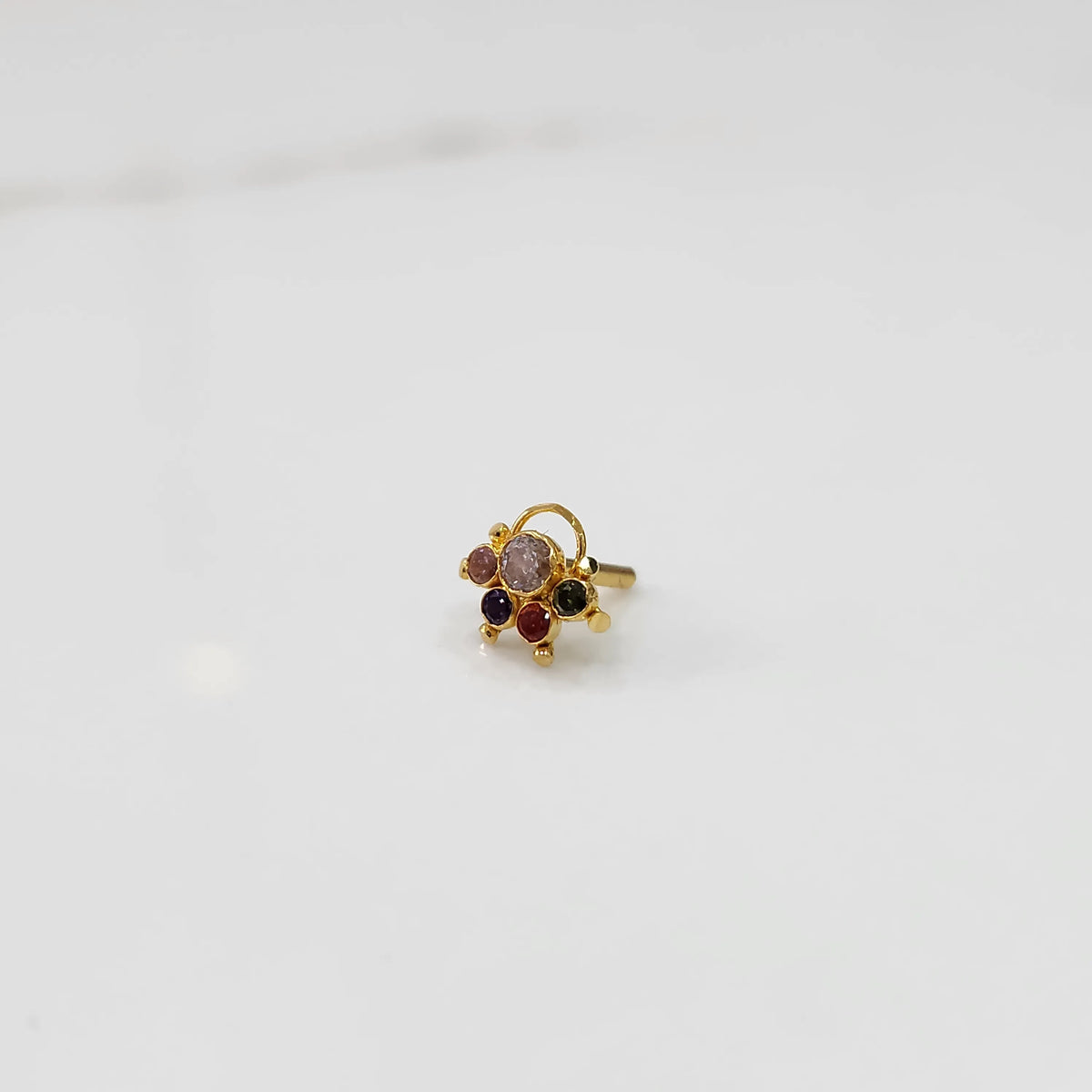 Gold ring with multicolor stone cluster in pink, red and black