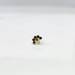 Front view of gold ring featuring green floral gemstones with clear center and drop pendant