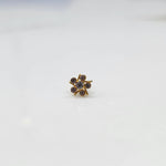 Close-up of gold ring featuring champagne gemstones with prong-set petals