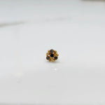 Front view of gold ring featuring blue and brown gemstone cluster in round floral pattern