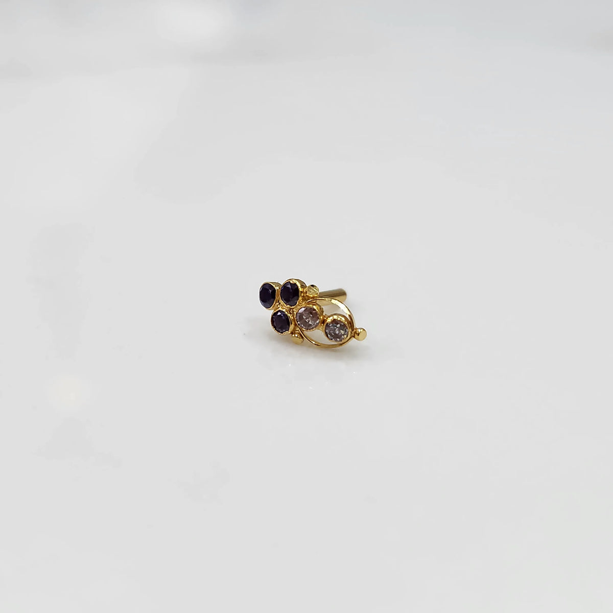 Gold ring with purple and clear round gemstone cluster design