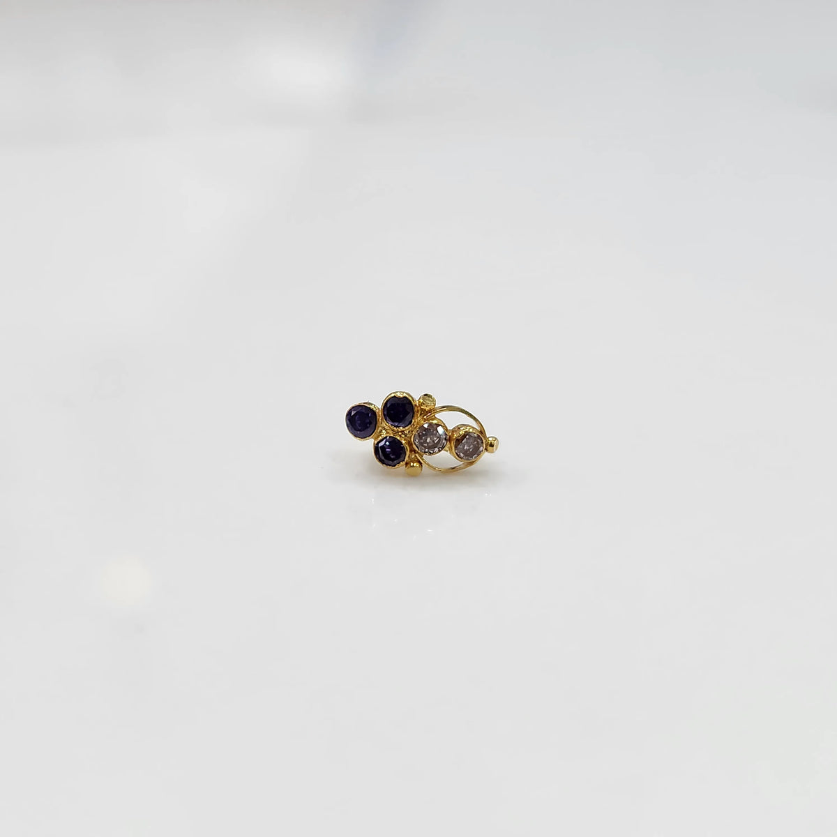 Gold ring with purple and clear round gemstone cluster design