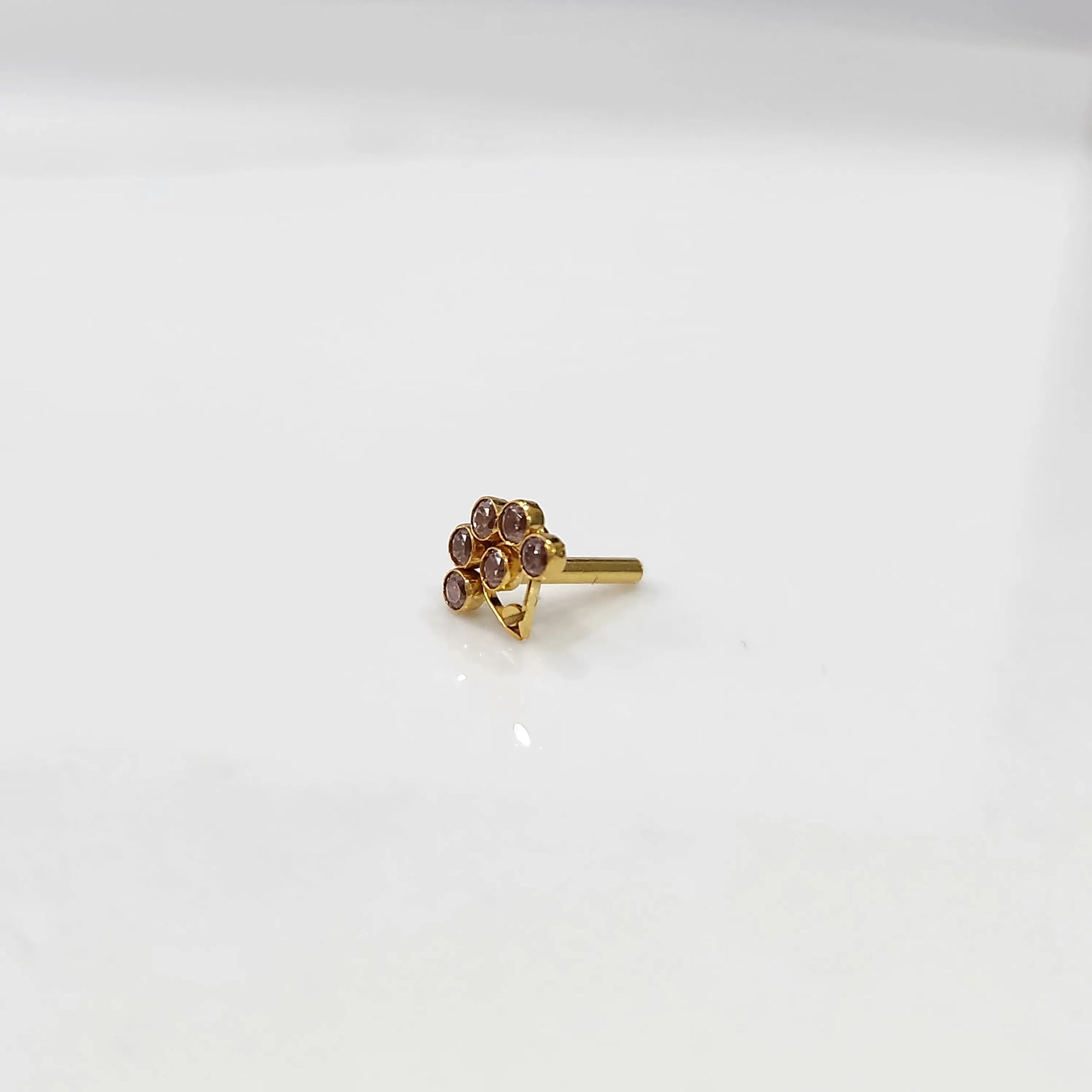 Gold ring with purple flower cluster design, front view