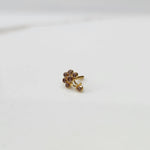 Gold ring with purple flower cluster and dangling drop stone