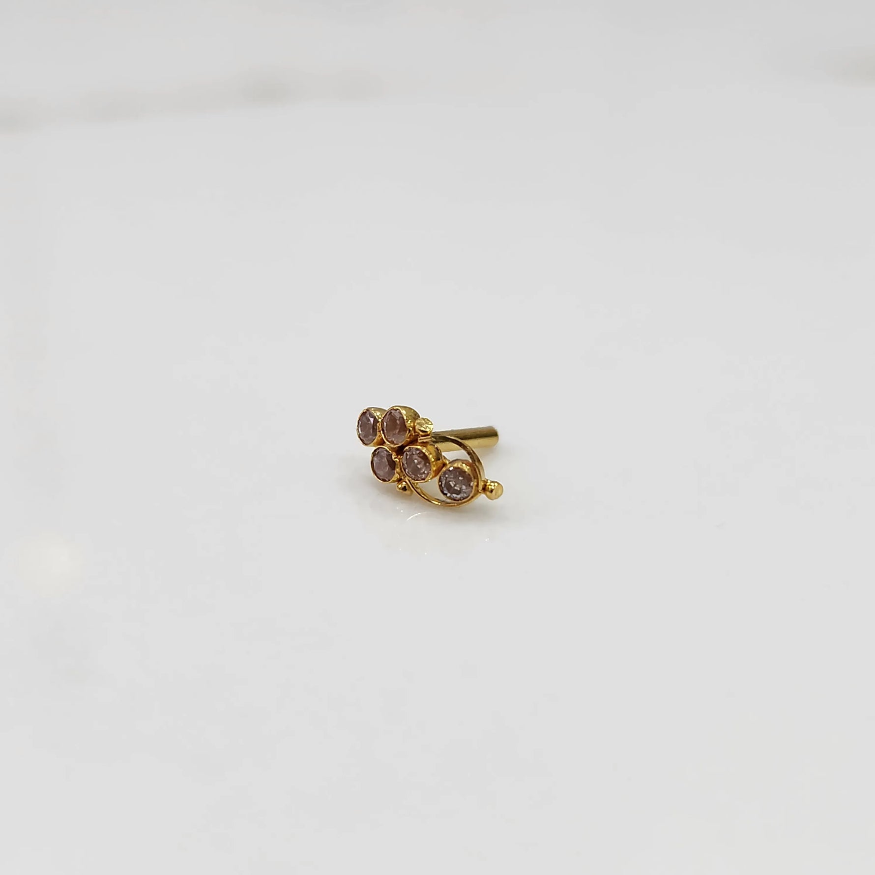 Gold ring with purple round gemstone cluster design