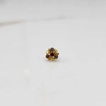Gold ring with red and smoky gemstone round floral design, front view