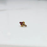 Gold ring with red ruby leaf-charm cluster design, side view