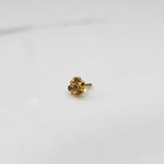 Side view of gold ring featuring brown gemstone cluster in round floral pattern