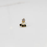 Gold ring with square clear stone and black gemstone drop design
