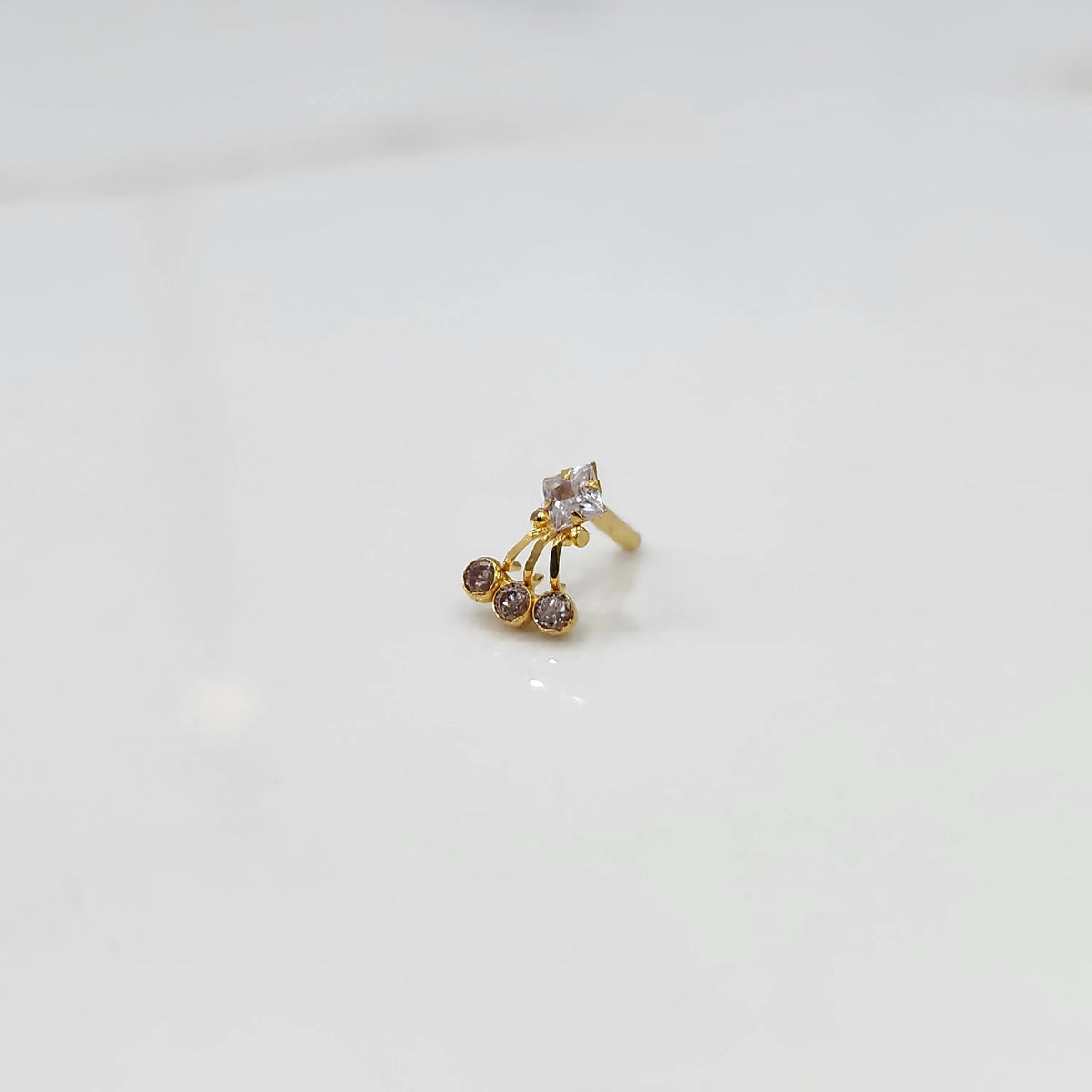 Gold ring with square clear stone and brown gemstone drop design