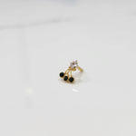 Gold ring with square clear stone and green gemstone drop design