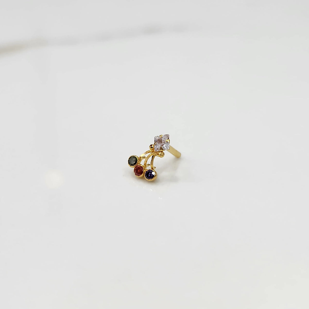 Gold ring with square clear stone and multicolor gemstone drop design