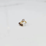 Gold ring with square clear stone and purple gemstone drop design