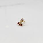 Gold ring with square clear stone and red gemstone drop design