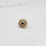 Gold round ring with clear and black gemstones, front view