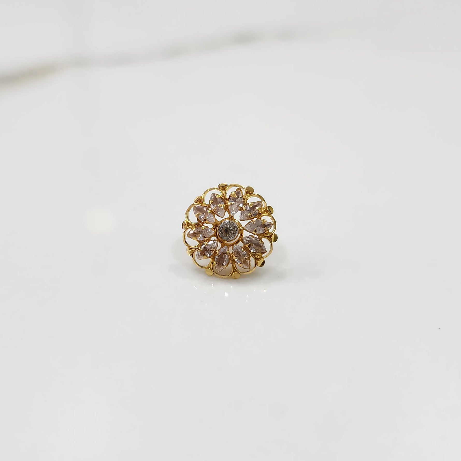 Gold round ring with clear gemstones, front view