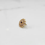 Gold round ring with clear and purple gemstones, front view