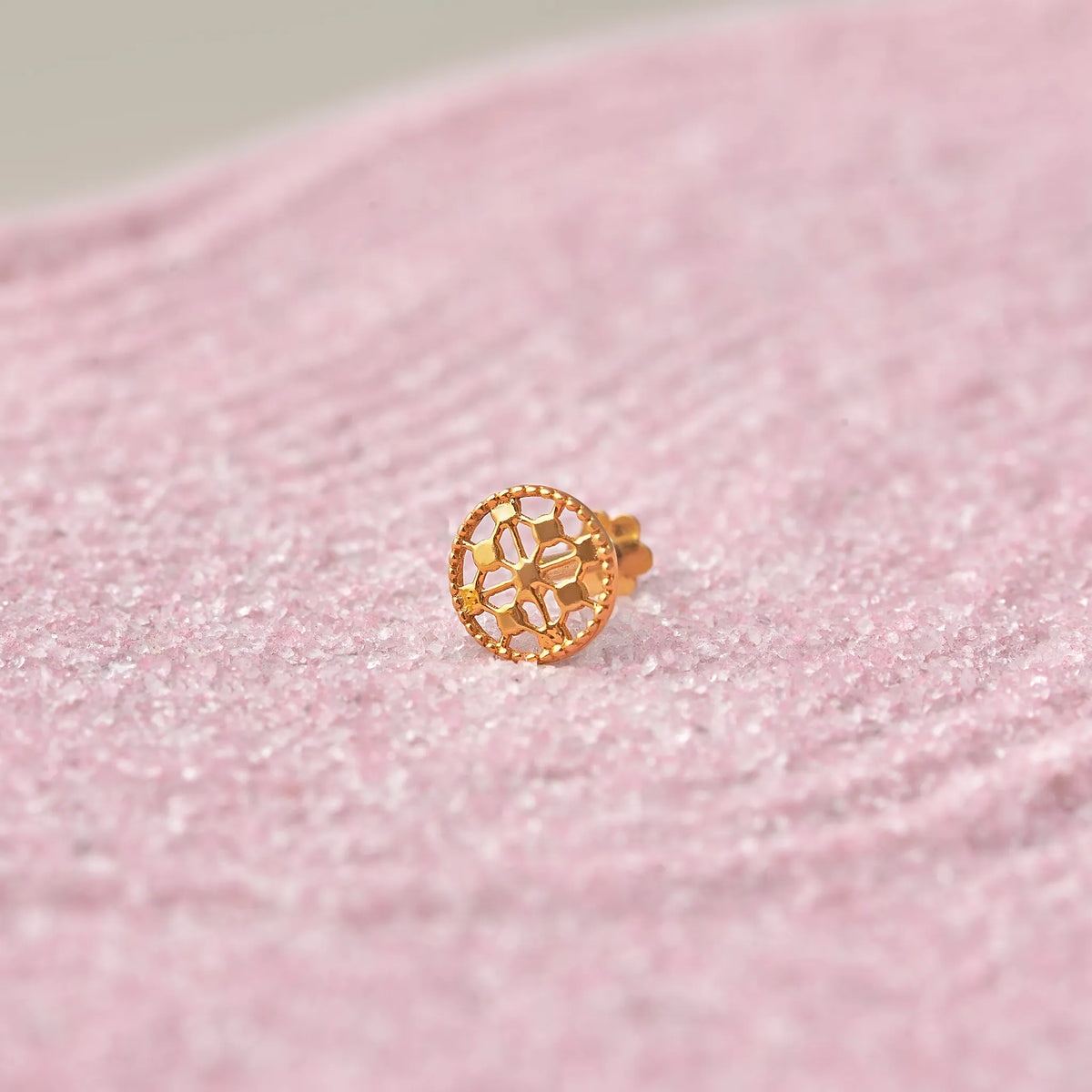 Gold round stud earring with honeycomb cutout design