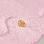 Gold round stud earring with textured leaf pattern