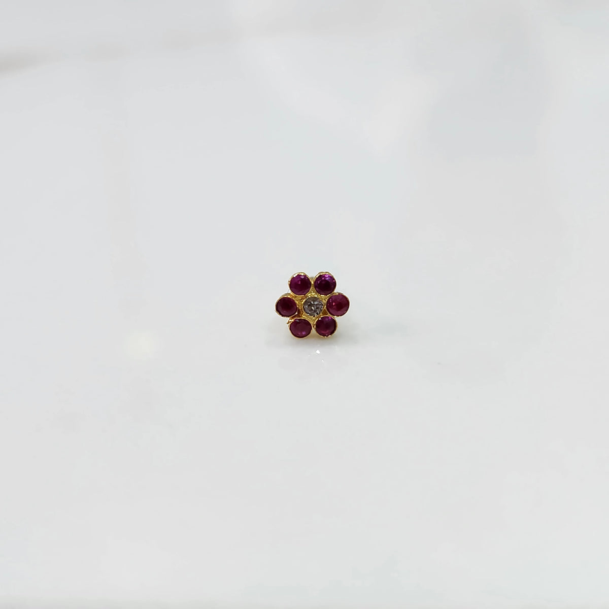 Nose pin design gold with tone floral pattern on white background