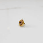 Traditional gold ring featuring a sapphire center with scalloped petal border