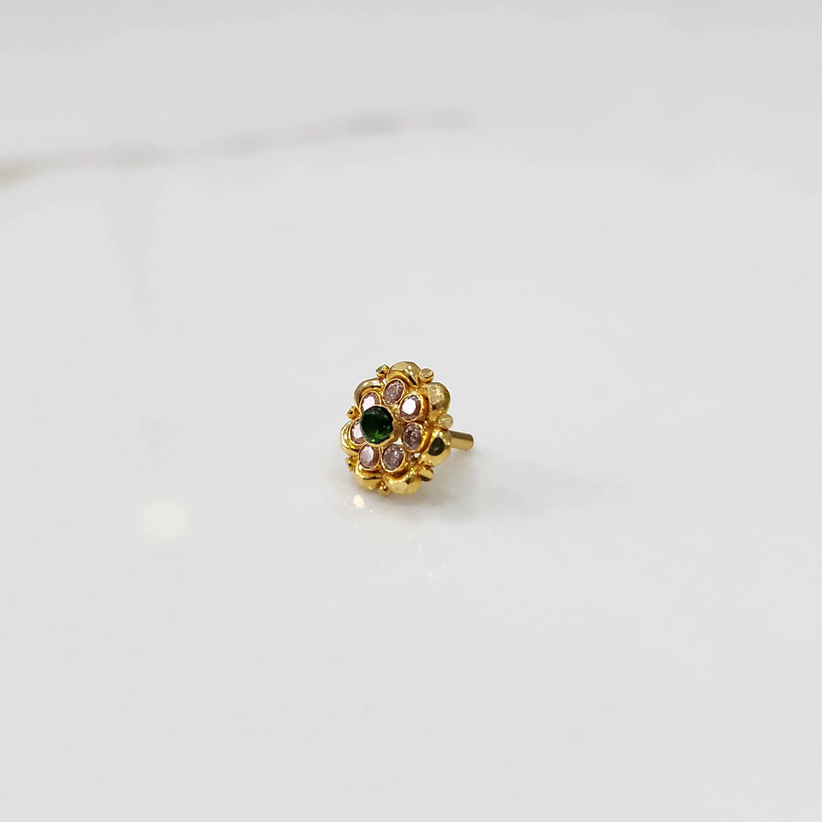 Gold floral ring with green center stone and champagne petal stones