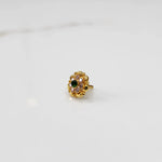 Gold floral ring with green center stone and champagne petal stones