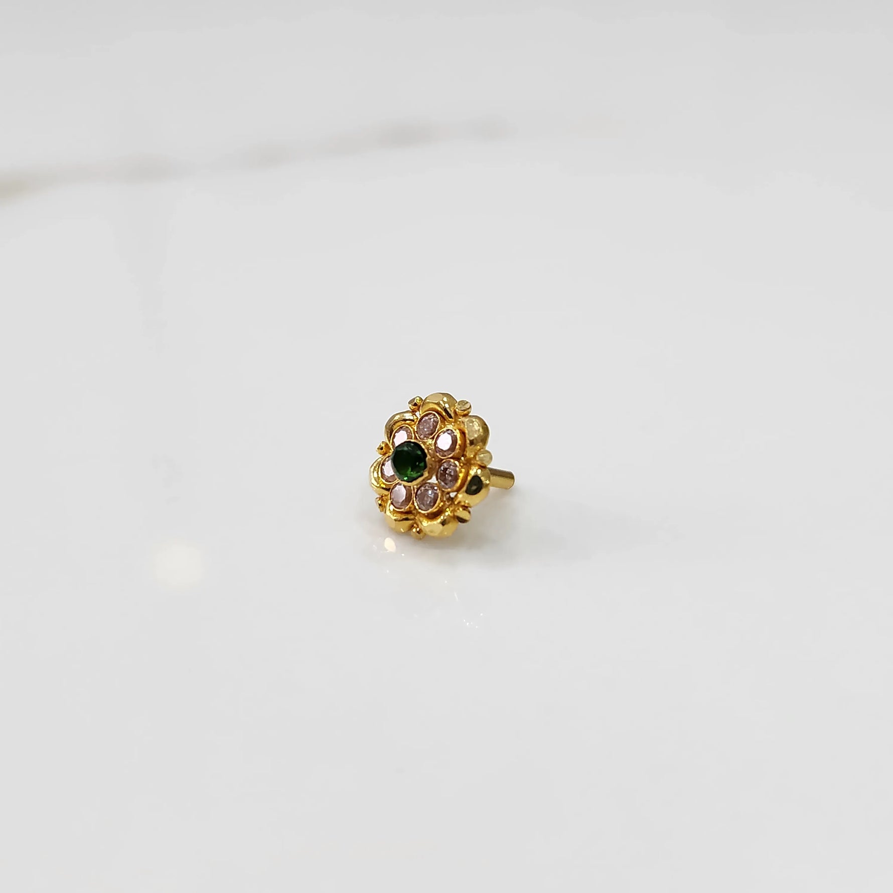 Gold floral ring with green center stone and champagne petal stones