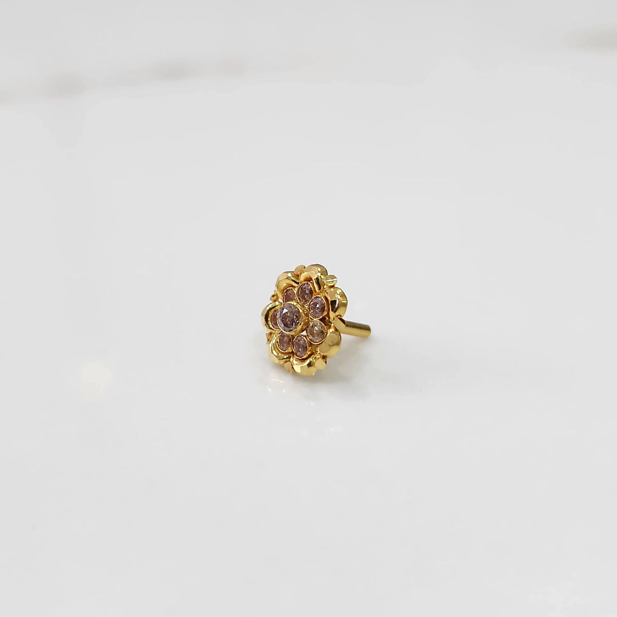 Gold ring with sculpted petal design and champagne stone detailing