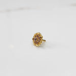 Gold ring with sculpted petal design and champagne stone detailing
