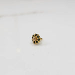 Gold ring with sculpted petal design and champagne center with green stones