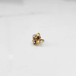 Gold ring with sculpted petal design and purple oval gemstones