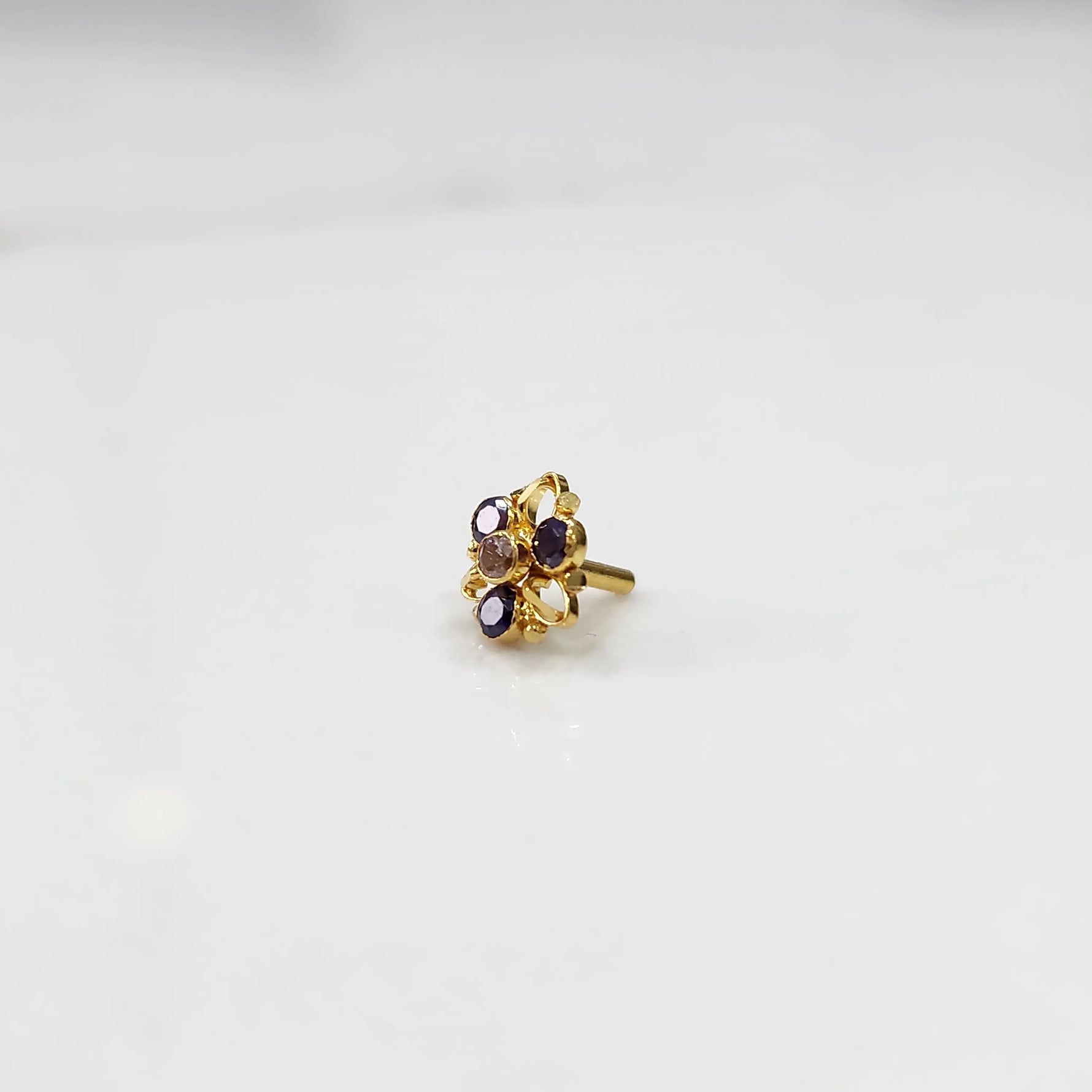 Gold ring with sculpted petal design and purple oval gemstones