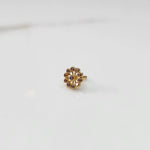 Large gold nose pin with smoky-toned gemstone petals and lilac center stone on white background