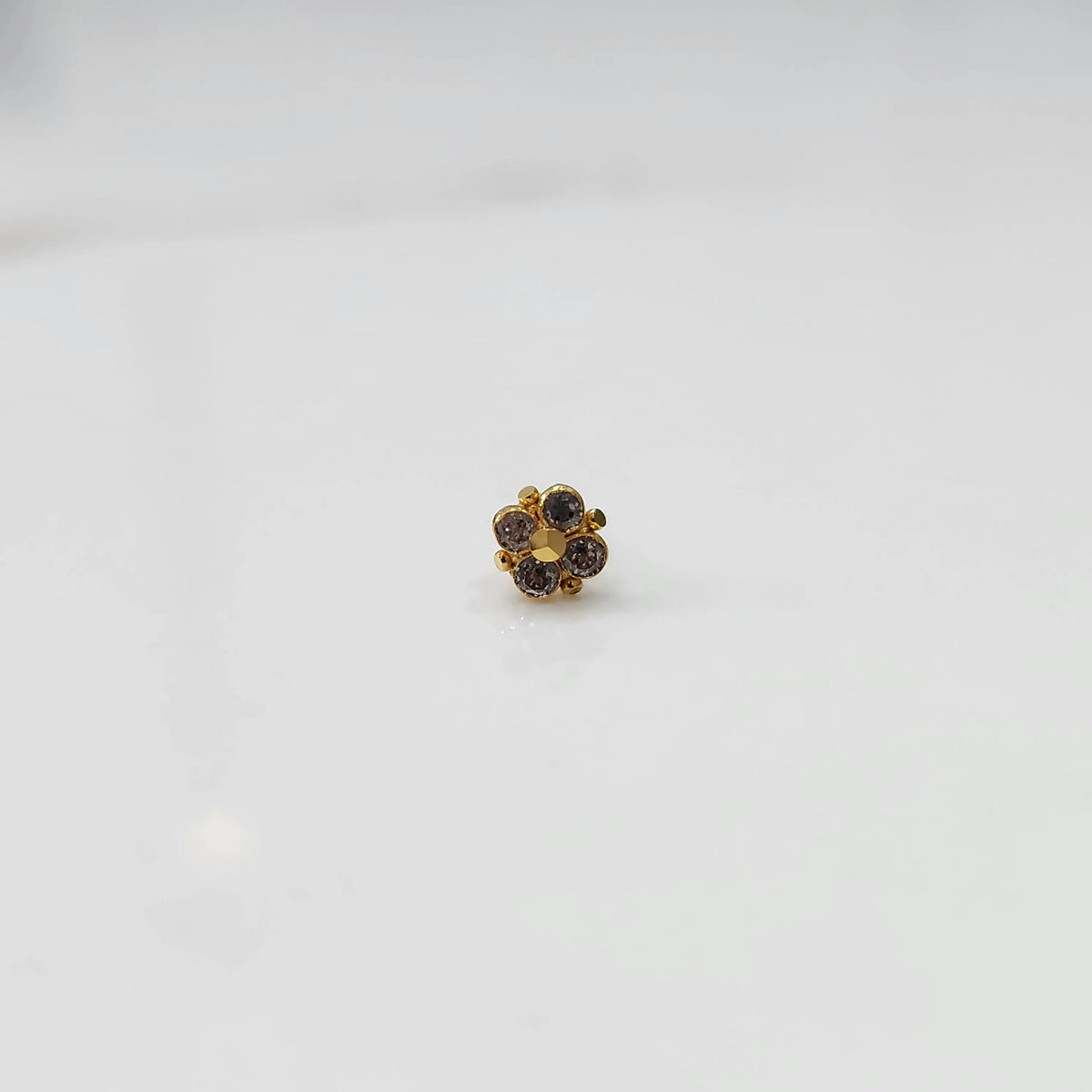 Gold floral nose pin with smoky topaz stones, product shot
