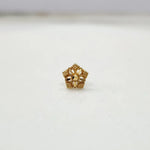 Front view of a gold star flower nose pin with beaded edge detailing