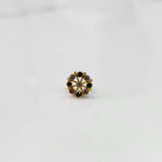 Gold pin nose with detailed floral gemstone pattern