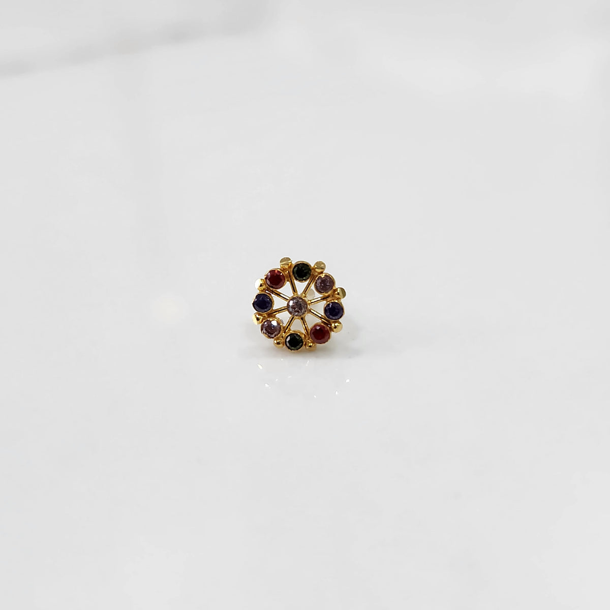 A gold star-frame stud earring with multicolor stones