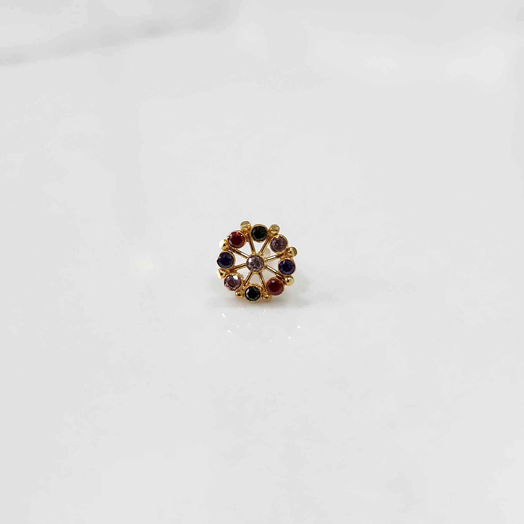 A gold star-frame stud earring with multicolor stones