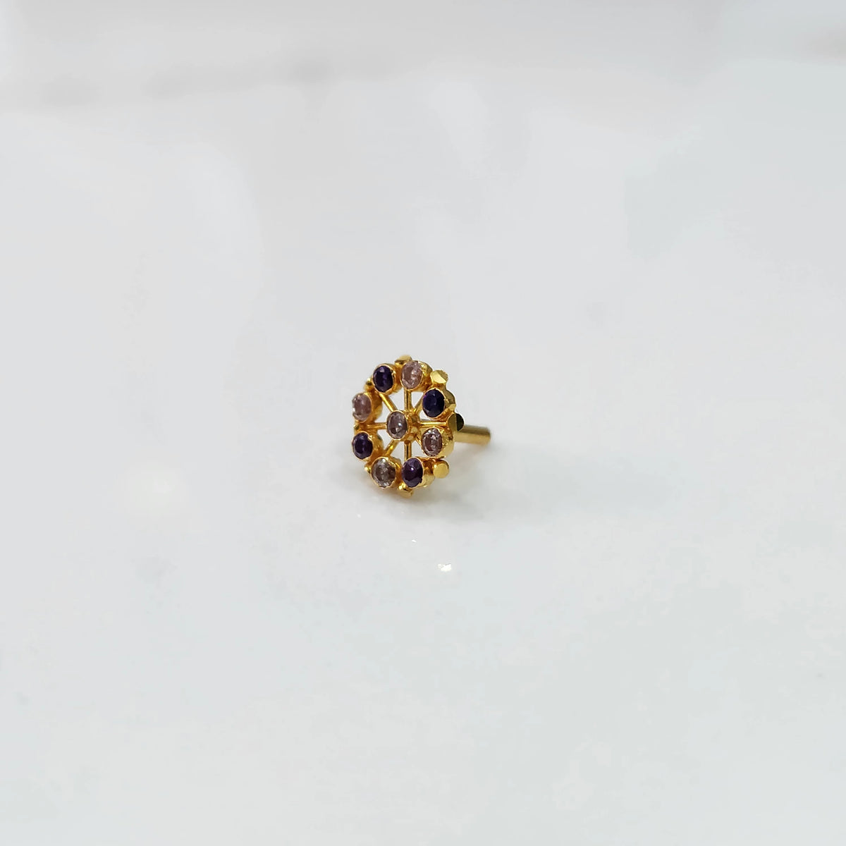 Side view gold pin nose with floral gemstone setting