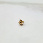 Close-up of a gold sunflower-shaped nose pin with screw-back fitting