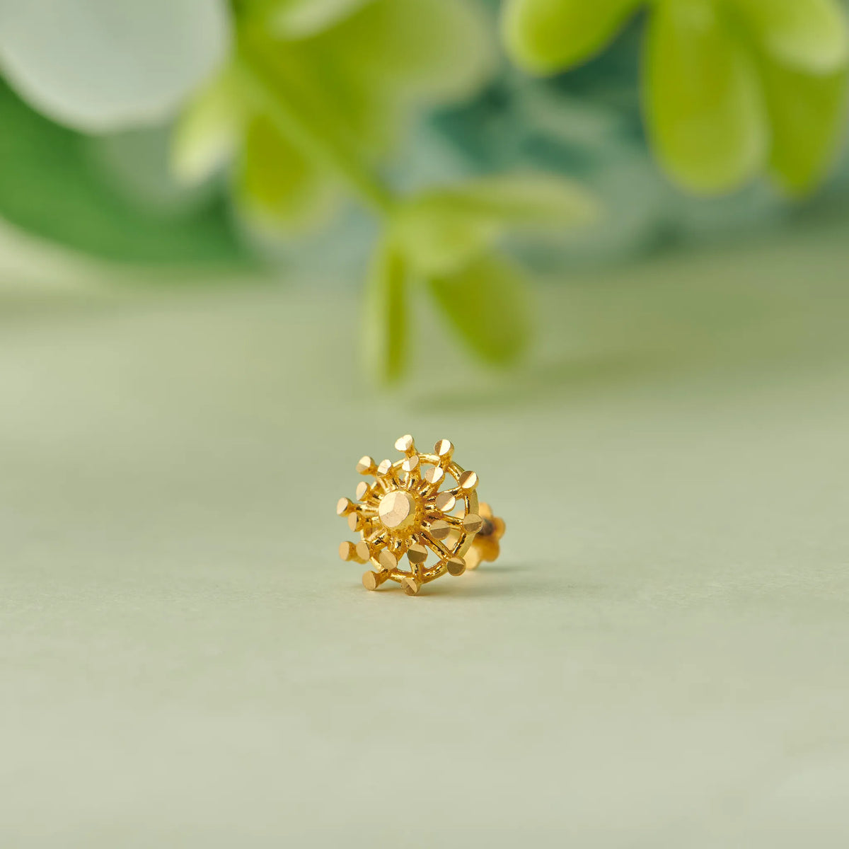 Gold sunflower-style stud earring with open-work petals