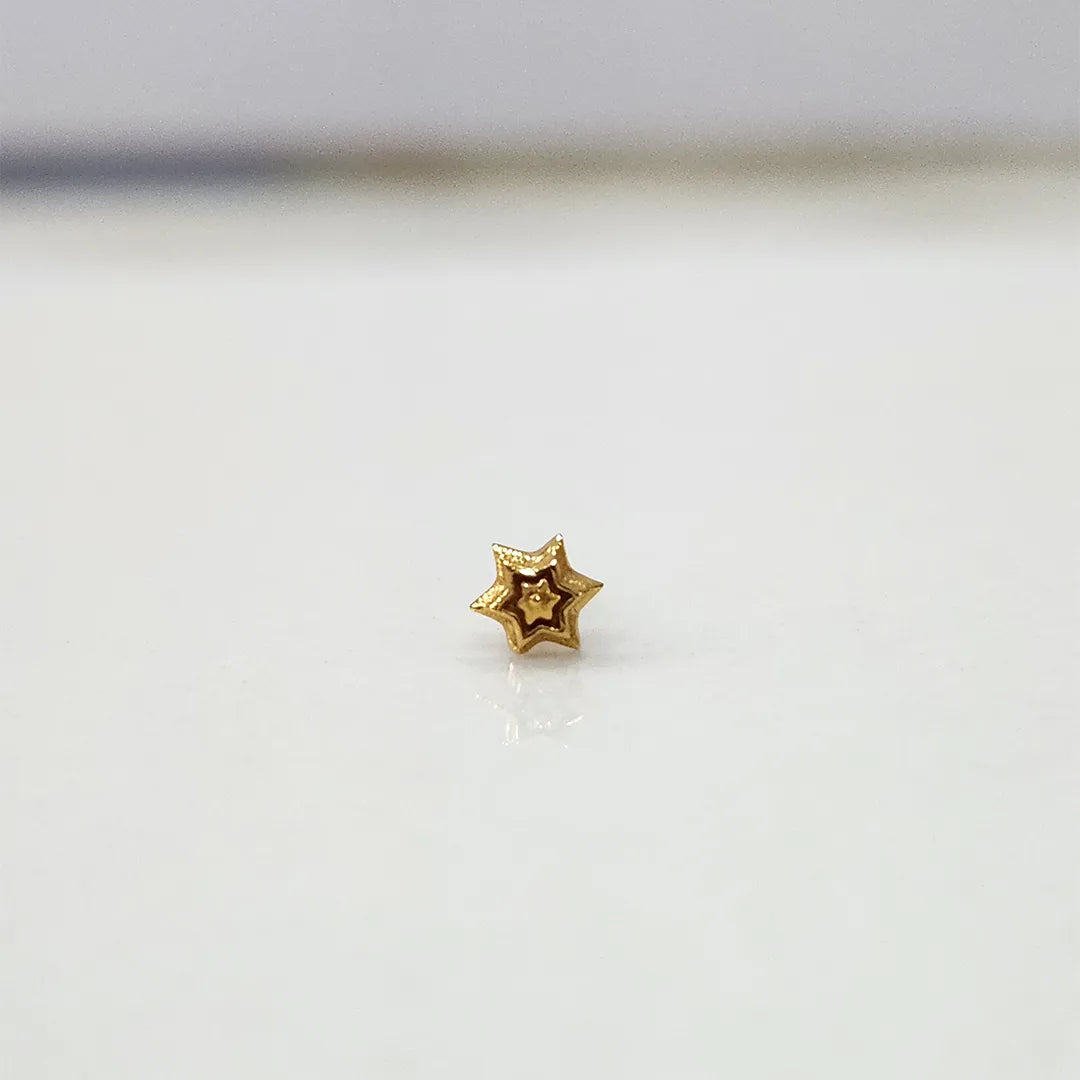 Simple gold nose pin design small star shape on white background