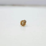 Front view of a round gold nose pin with beaded border on a white background