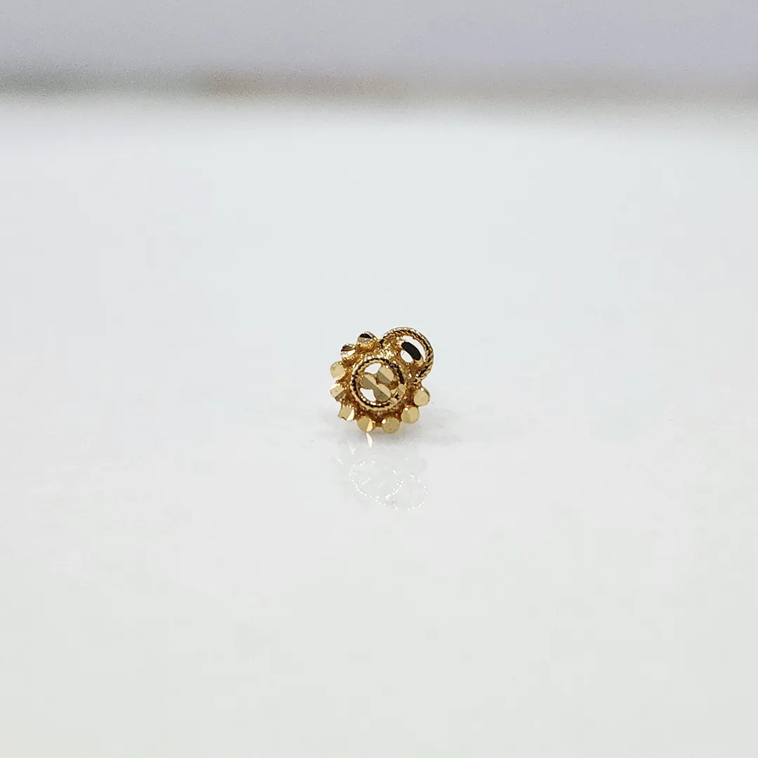 Front view of a round gold nose pin with beaded border on a white background