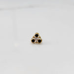 Top view of gold ring with black and clear stone cluster 