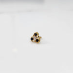 Gold ring with three-stone cluster in black and clear stones